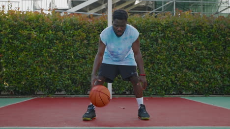 man dribbling basketball on court