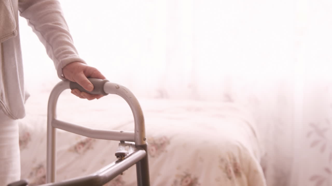 Female doctor assisting a senior woman to walk