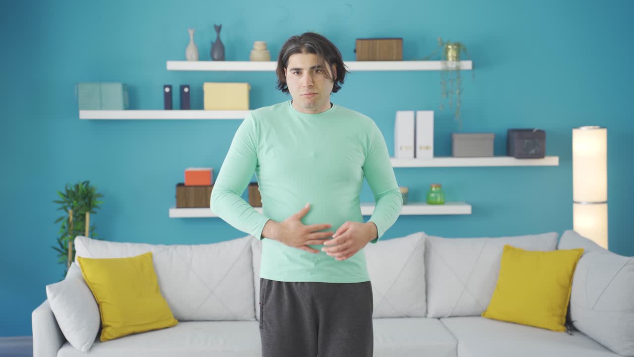 Funny and overweight sportsman doing sports looking in the mirror.
