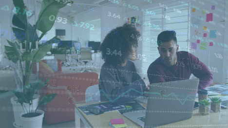 Animation-of-stock-market-data-processing-on-diverse-man-and-woman-discussing-over-laptop-at-office