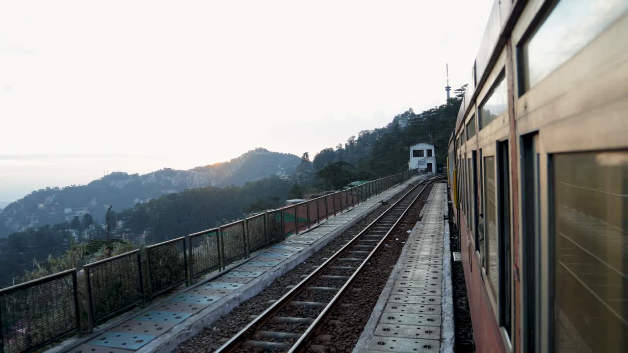 passenger train window view along mountain railway at sunset video is taken at shimla himachal pradesh india