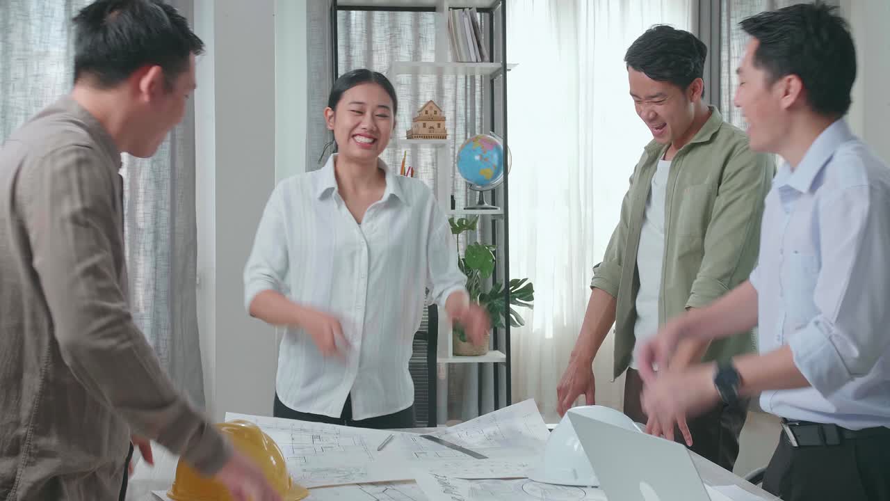 Group Of Asian Engineers Celebrating Finish Working At The Office