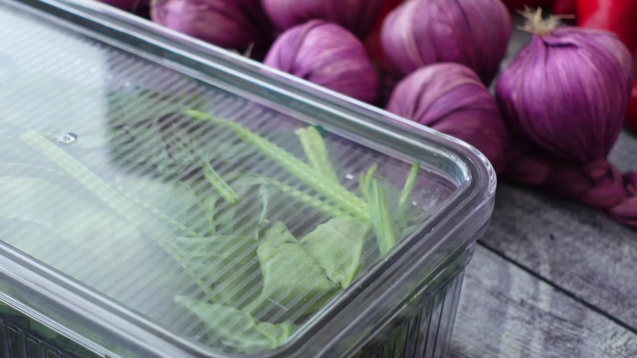 Spinach and onions in plastic containers