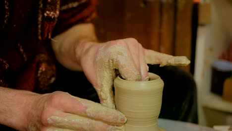 professional male potter working in workshop