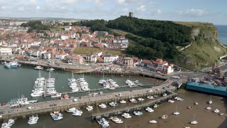 Aerial-bird's-eye-view-of-Scarborough-harbor,-boats-and-castle