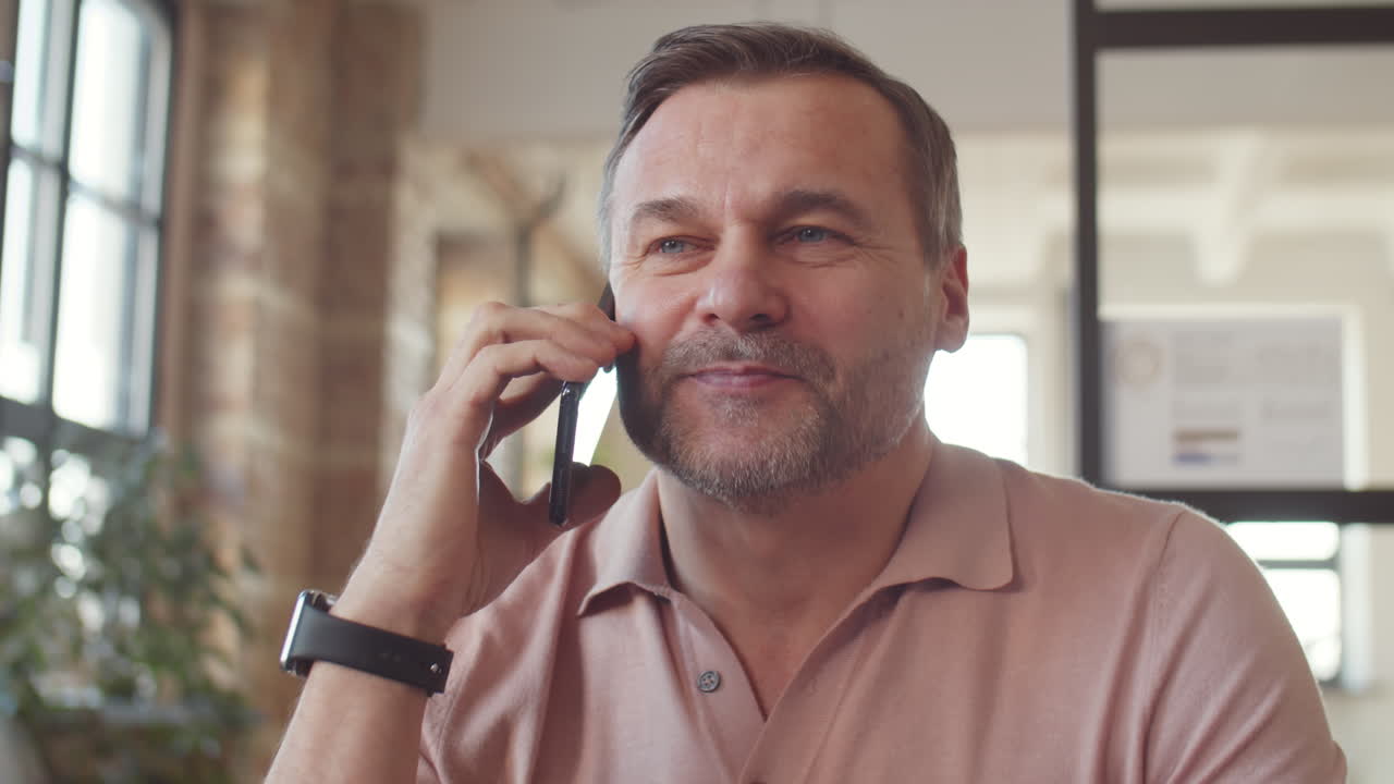Middle-aged Man on Phone in Office