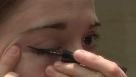 Applying eyeliner