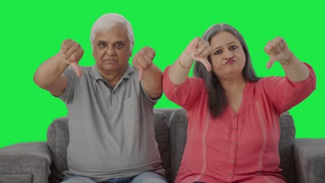 Disappointed-Indian-old-couple-showing-thumbs-down-Green-screen