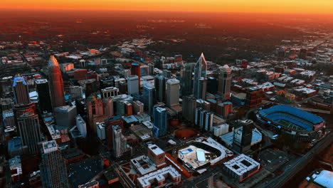 impressive orange sky above the immense scenery of a big american city. panorama of charlotte, north carolina, usa at dusk from top