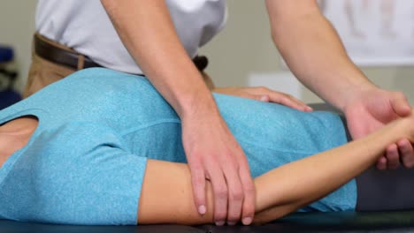 male physiotherapist giving arm massage to female patient