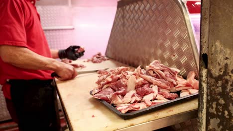 butcher slicing meat on a table