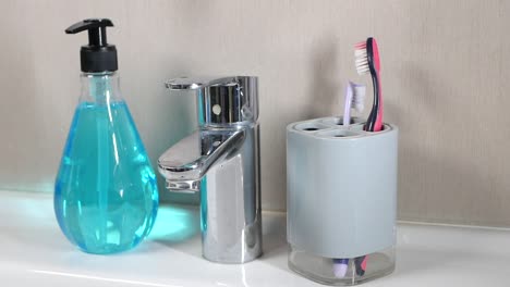 bathroom sink with toothbrush holder, soap dispenser, and faucet