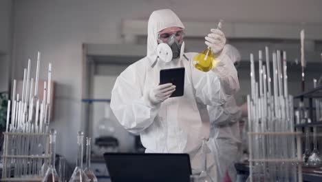 modern laboratory scientists work in protective suits and respirators