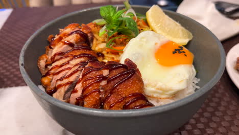 thai crispy fried duck with fried egg, vegetables and white rice, spicy asian food, 4k shot