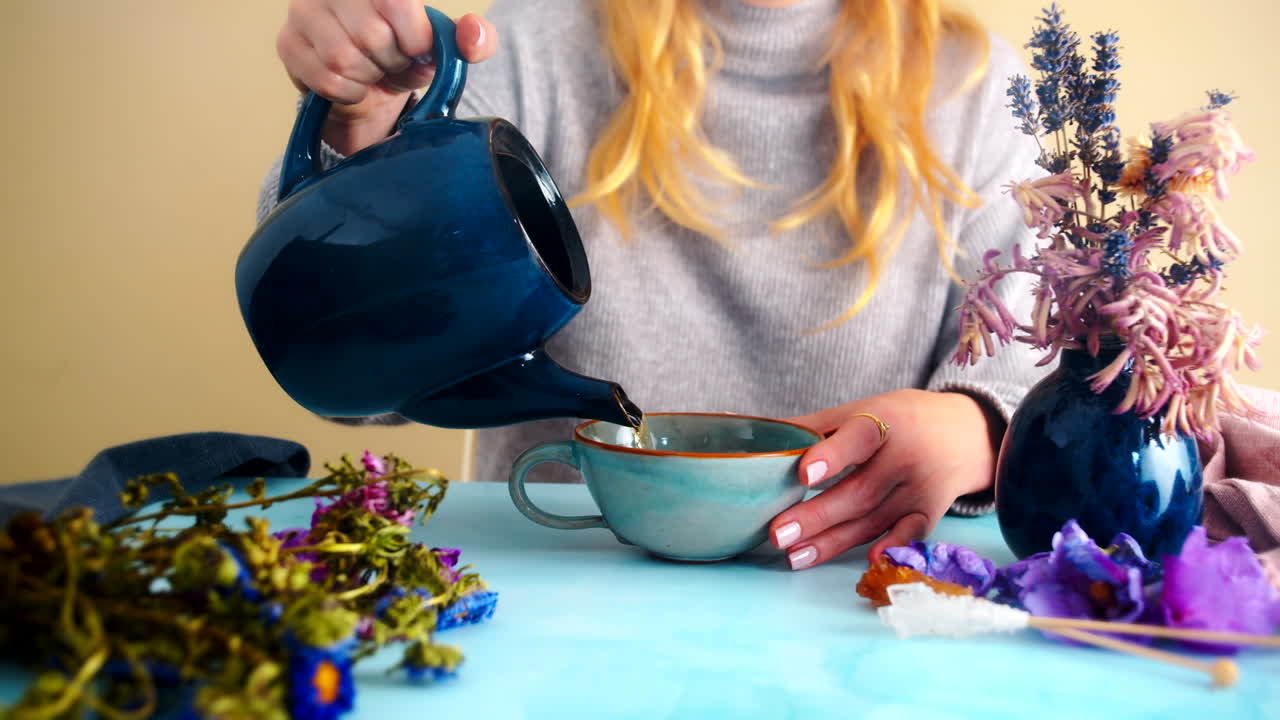 Woman Pouring Tea in Cozy Atmosphere