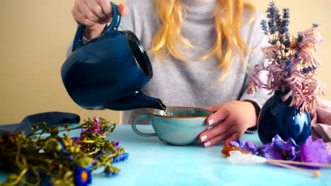 woman pouring tea in cozy atmosphere