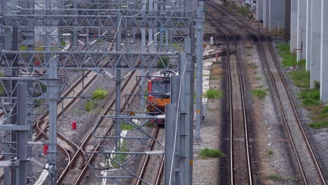 a single train coach moving past bang sue train station in bangkok, thailand