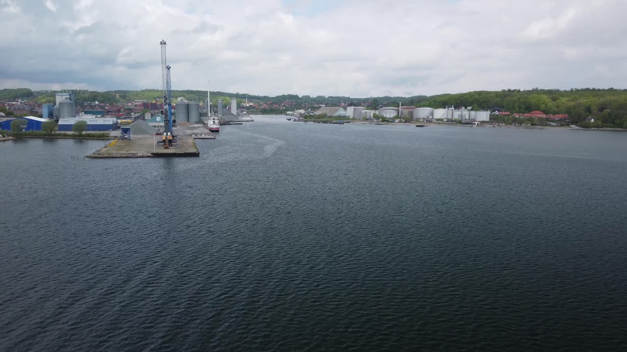 Aabenraa harbor view with industrial buildings and calm water, shot from a drone