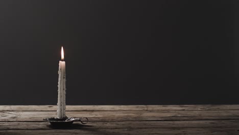 video de una vela de halloween con humo y espacio de copia sobre un fondo de madera y negro