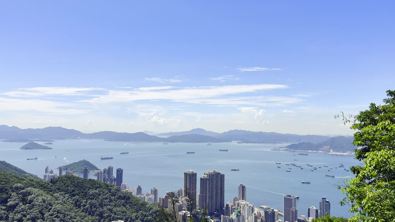 Footage of Hong Kong city skyline and sea as seen from Victoria Peak, showcasing panoramic views of skyscrapers, Victoria Harbour, and coastal scenery, highlighting iconic travel and urban landscapes