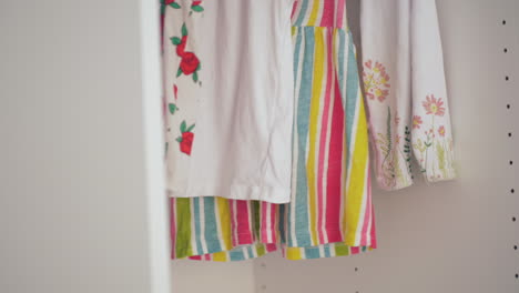 hanging child clothes in the wardrobe