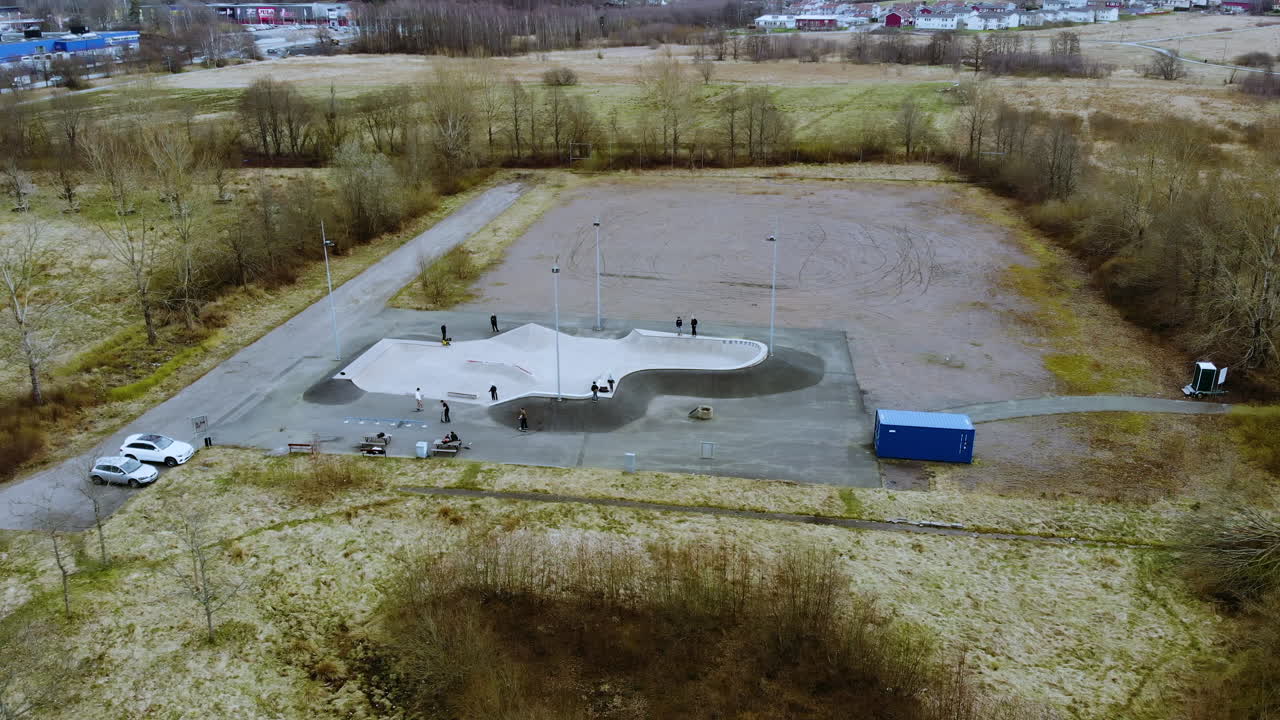 Skaters Having Fun At The Skatepark In Kållered, Mölndal, Sweden - aerial trucking shot
