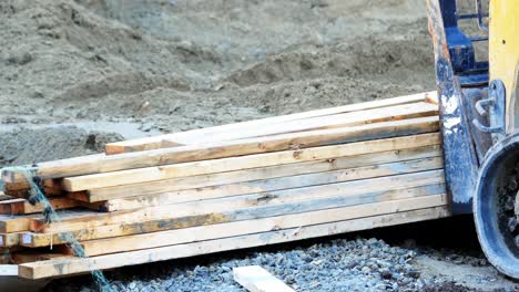 Forklift-loading-wooden-plank