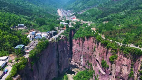 aerial establishing shot of the huixian city built above the guoliang tunnel, china