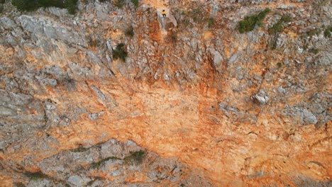 A-person-flying-a-drone-on-the-edge-of-Red-Lake-the-biggest-doline-in-Europe