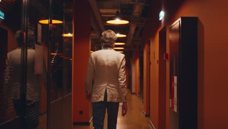 a man walks through a modern office hallway