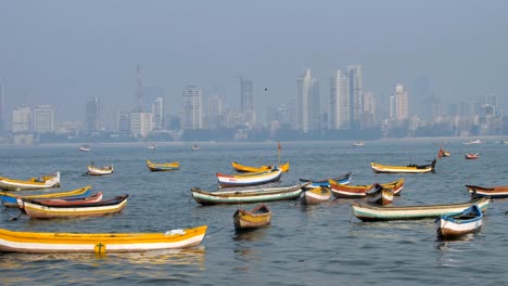 fishing boats are parked in the arabian sea against the indian city skyline