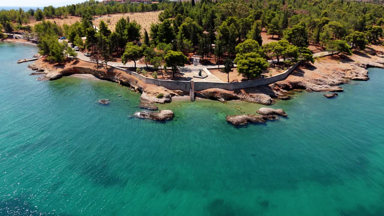 Drone reveals small wooden cabins along turquoise cove in Galaxidi’s forested coastline