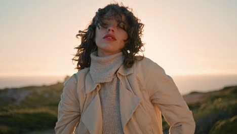 lonely woman embracing herself at sunset sky vertical. upset thinking girl pose