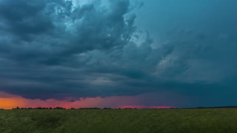 timelapse of dramatic stormy sky at dusk over meadow