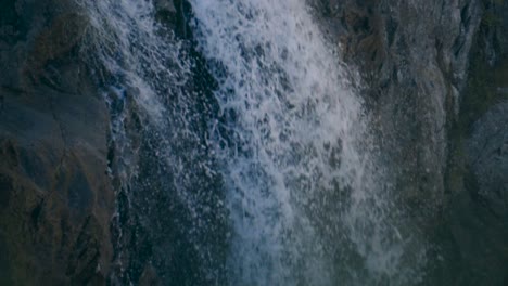 A-wild-mountain-river-with-crystal-clear-water-falling-down-in-a-close-up-shot