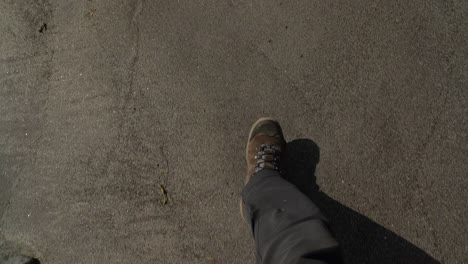 Pov-view-of-walk-with-hiker-shoes-on-White-sandy-beach-at-Sandur-on-Sandoy-during-daytime