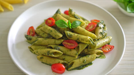 penne pasta with pesto sauce and tomatoes - vegan and vegetarian food style