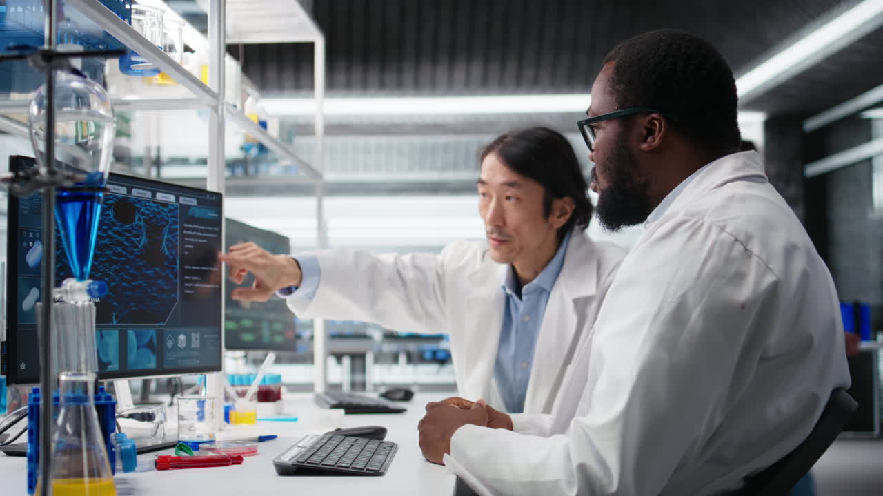 Vertical video Multiracial engineers using scientific gear in research facility