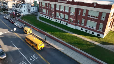 school bus and students at public school building