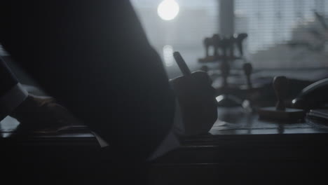 man signing a document at an office desk