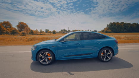 audi customers test the new audi e-tron electric car. electric metallic blue audi e-tron 55 quattro suv.