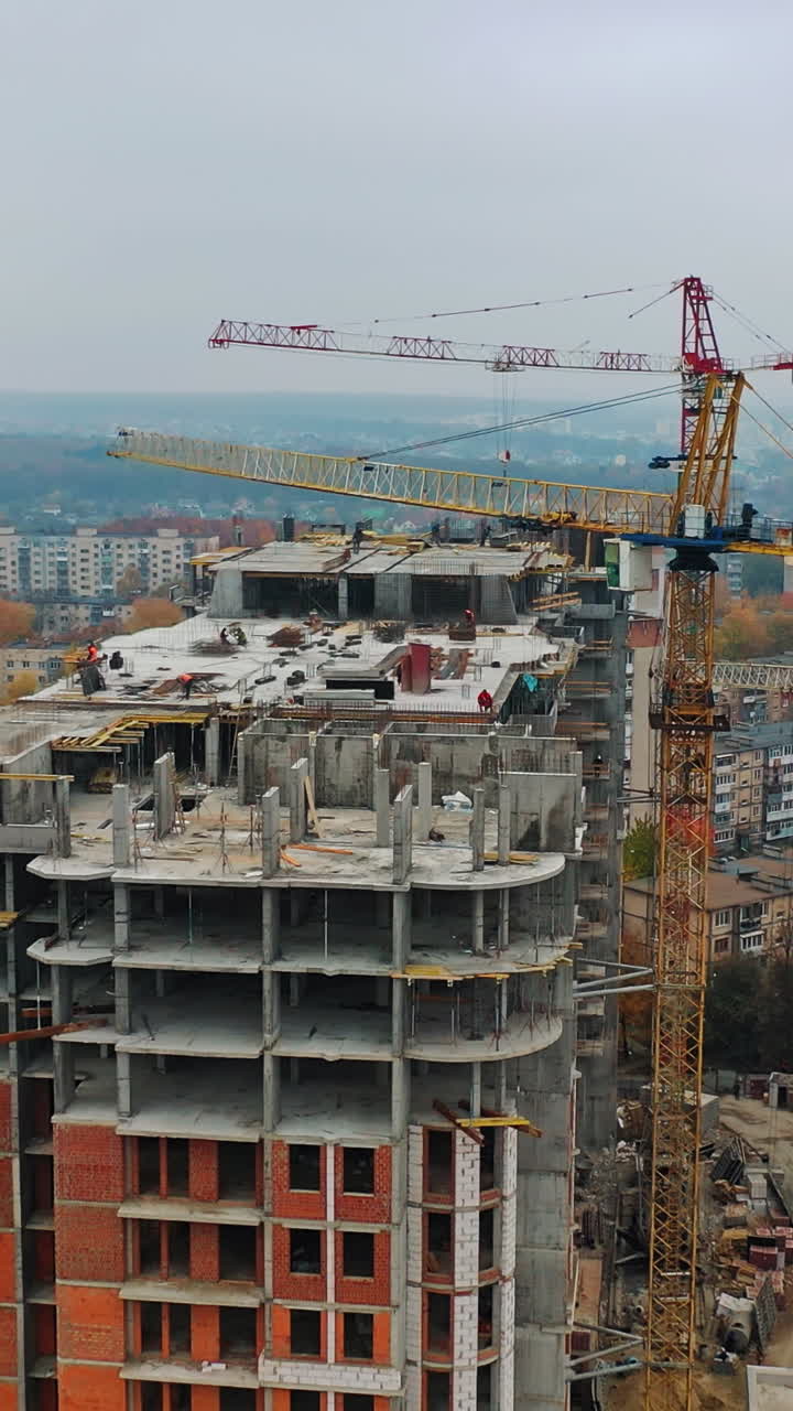 Construction of a residential apartment complex. Aerial view. Vertical video