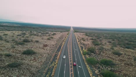 Aerial-view-of-main-highway-along-Big-Island,-Hawaii-at-sunset