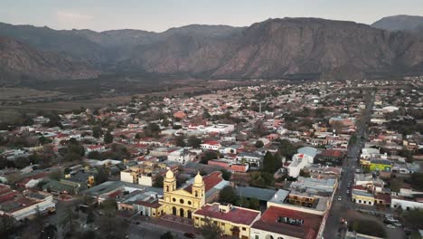 bird's-eye view of a sunrise in cafayate, capturing the vibrant plaza de cafayate and the iconic cathedral of our lady of the rosary