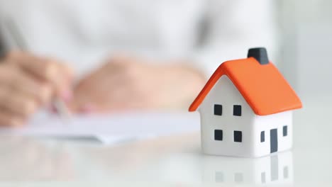 woman signing a mortgage or insurance contract