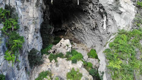 aerial shot descending into the mouth of a cave at dong van, vietnam