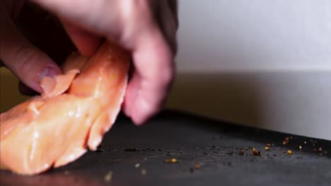 raw fresh salmon fillet placed onto hot pan, home cooking, slow motion closeup