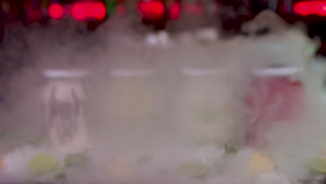 smoke reveal of colourful frozen smoothie jars on bar