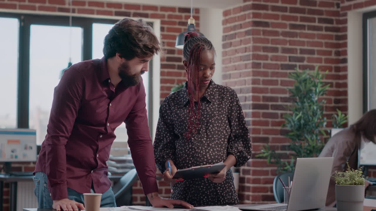 Pregnant woman and man working on marketing strategy