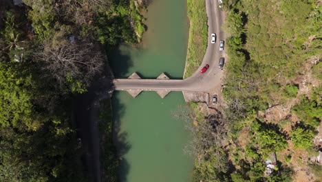 cars driving over flat bridge from a drone view